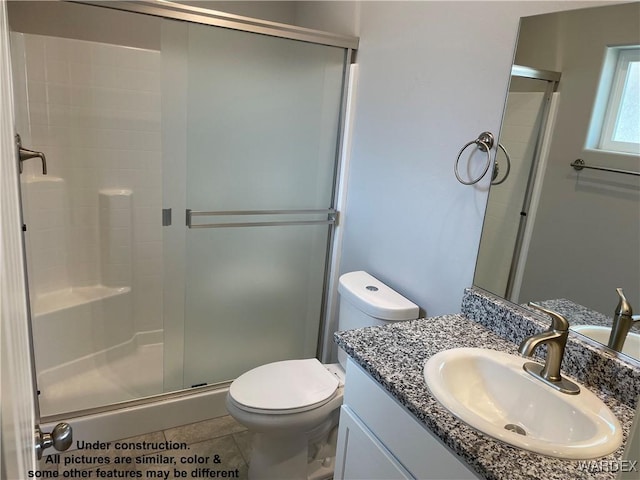 full bathroom featuring tile patterned flooring, toilet, a shower stall, and vanity