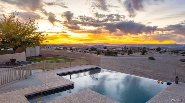 view of swimming pool with a patio area, a fenced backyard, a mountain view, and a fenced in pool