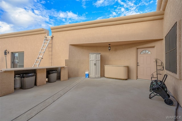 exterior space with a patio area and stucco siding