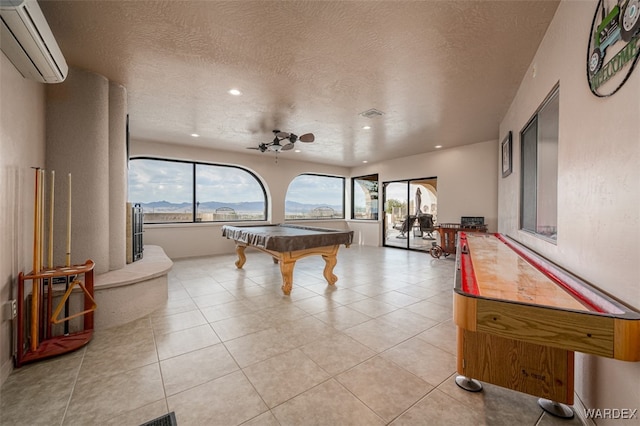 recreation room with light tile patterned floors, billiards, a ceiling fan, a mountain view, and a wall mounted AC