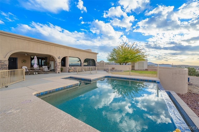 view of swimming pool with a fenced in pool, a patio, and fence