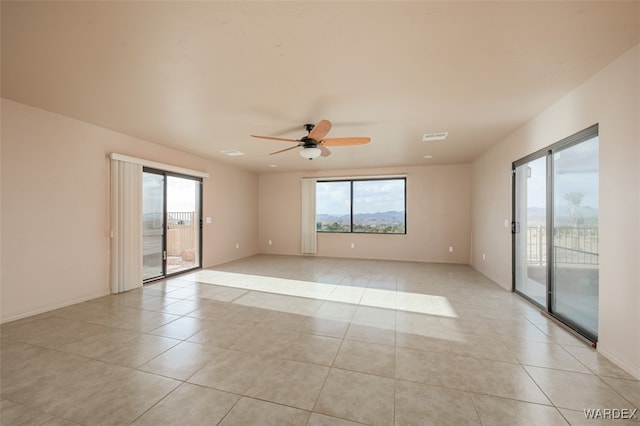 spare room with visible vents, plenty of natural light, and light tile patterned flooring