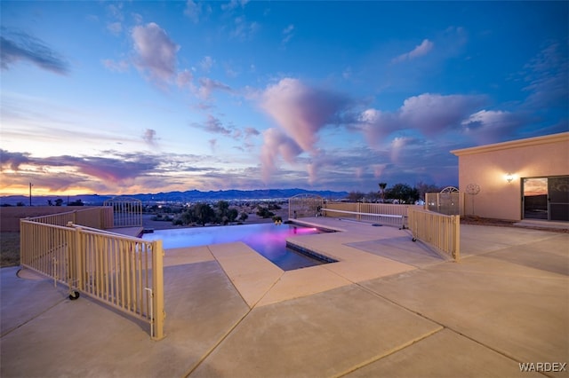 outdoor pool featuring fence private yard, a patio area, and a mountain view