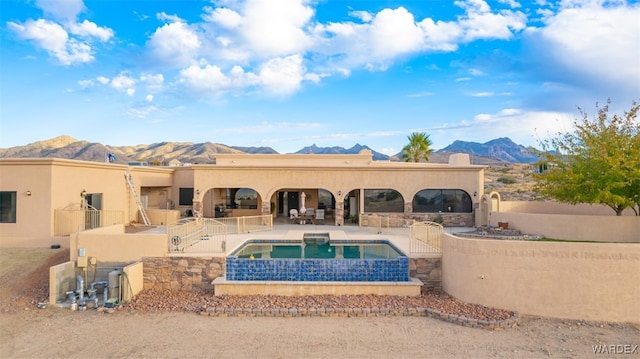 back of property featuring a patio, a fenced backyard, a mountain view, area for grilling, and stucco siding