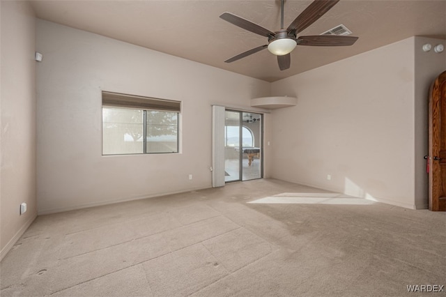 empty room with light carpet, visible vents, and a ceiling fan