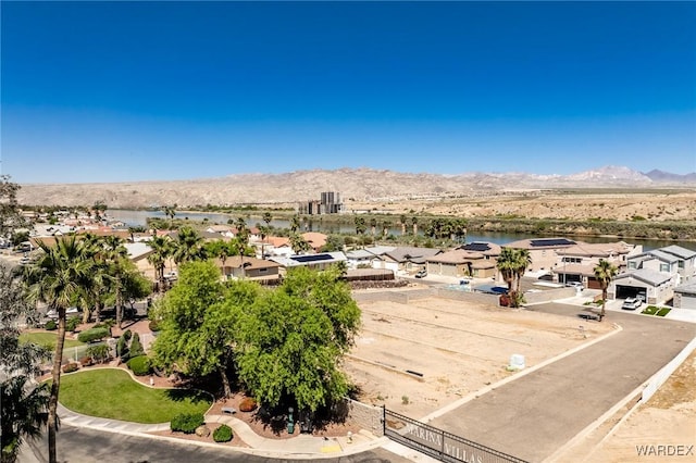 drone / aerial view with a residential view and a water and mountain view