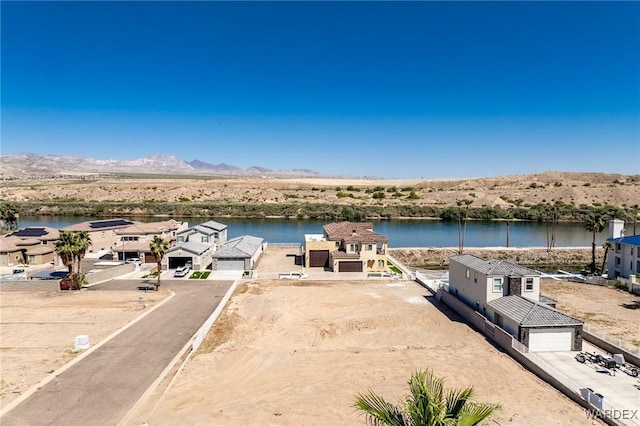 drone / aerial view featuring a residential view and a water and mountain view