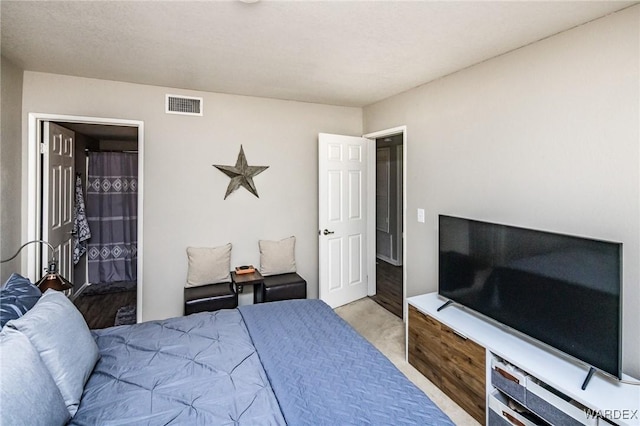 bedroom with light carpet and visible vents