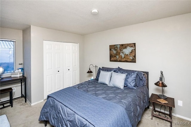 carpeted bedroom with baseboards and a closet