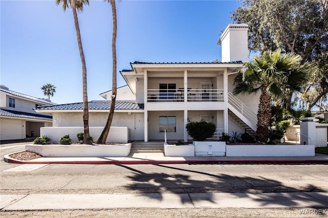 view of front of home featuring a chimney and stucco siding