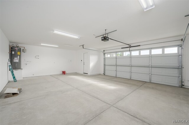 garage featuring water heater and a garage door opener