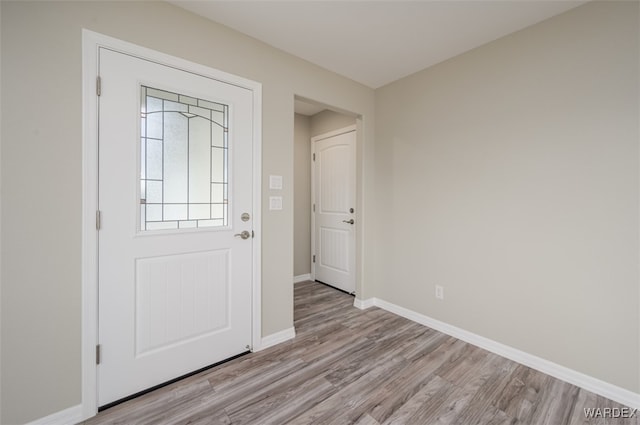 entrance foyer featuring light wood-style flooring and baseboards