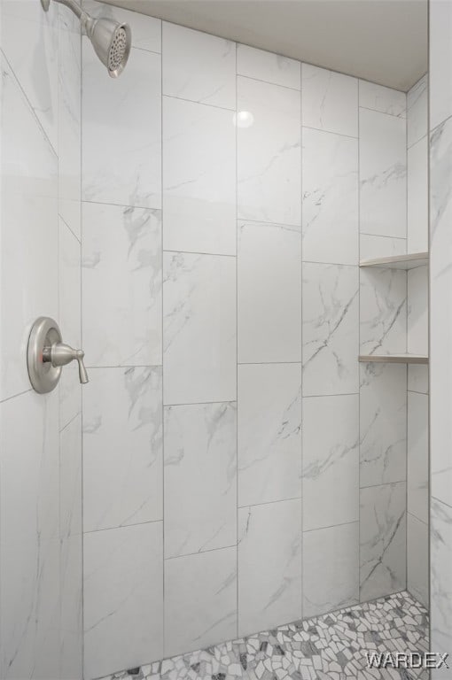 bathroom with a tile shower