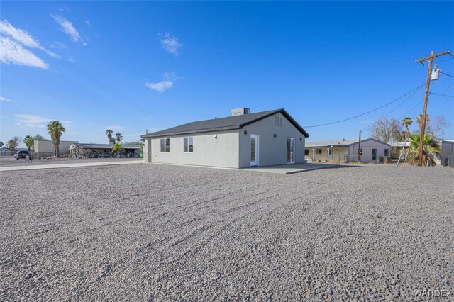 rear view of property with stucco siding