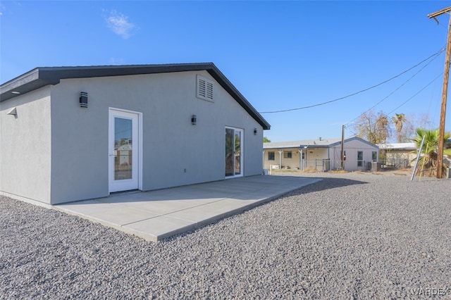 back of property featuring a patio, fence, and stucco siding