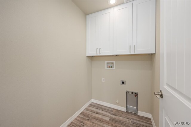 laundry area with cabinet space, baseboards, light wood-style flooring, washer hookup, and electric dryer hookup