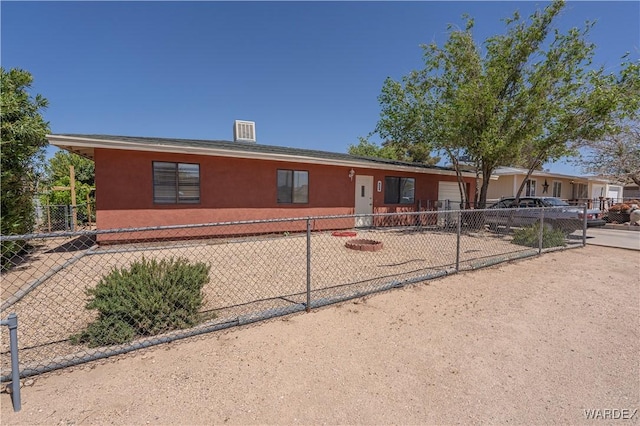 single story home featuring an attached garage, fence, and stucco siding