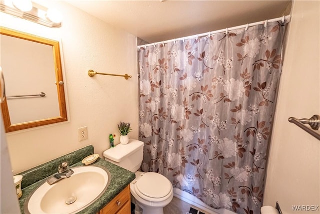 bathroom featuring vanity, toilet, and a shower with curtain