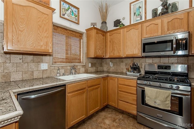 kitchen featuring a sink, backsplash, and appliances with stainless steel finishes