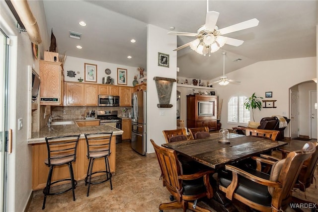 dining space featuring visible vents, recessed lighting, arched walkways, lofted ceiling, and ceiling fan