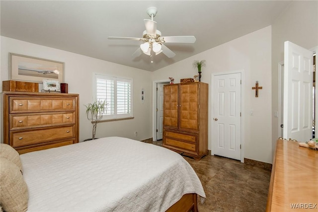 bedroom featuring baseboards, lofted ceiling, and ceiling fan