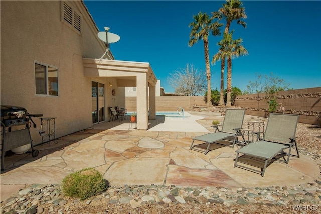 view of patio / terrace with a fenced backyard, a fenced in pool, and a grill