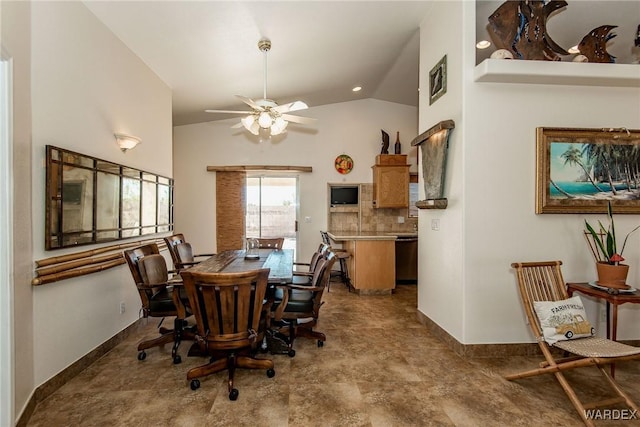 dining room with baseboards, ceiling fan, and vaulted ceiling