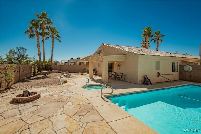 view of pool with a patio area, a fenced in pool, an in ground hot tub, and a fenced backyard