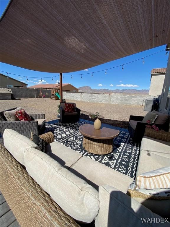 view of patio / terrace with a fenced backyard, outdoor lounge area, and a playground