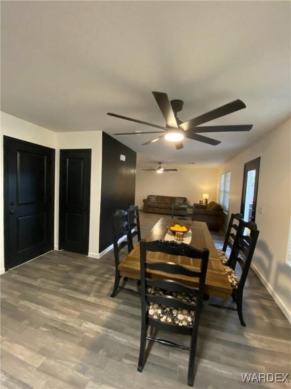 dining area with baseboards, a ceiling fan, and wood finished floors