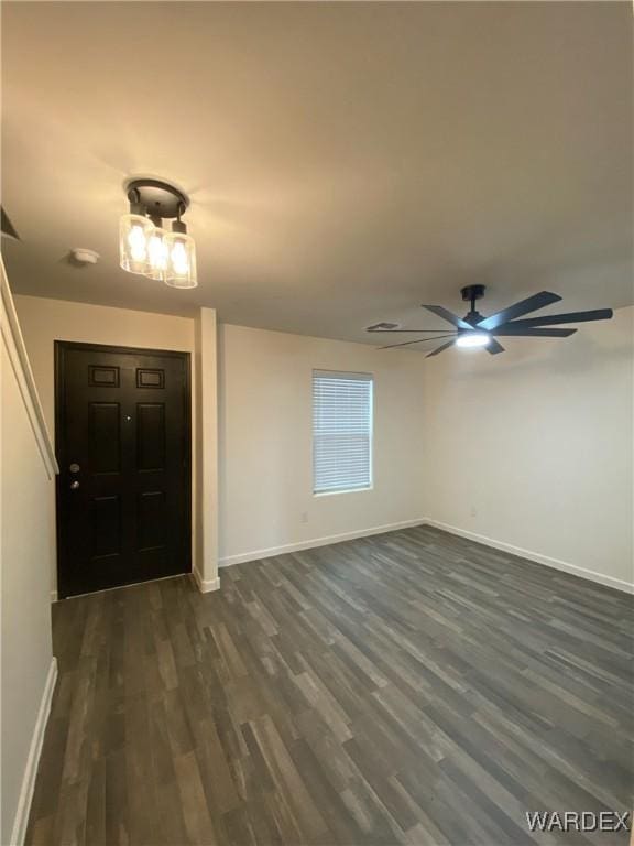 entryway featuring baseboards, a ceiling fan, and dark wood-style floors