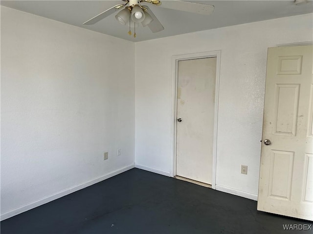 unfurnished bedroom with finished concrete flooring, ceiling fan, and baseboards