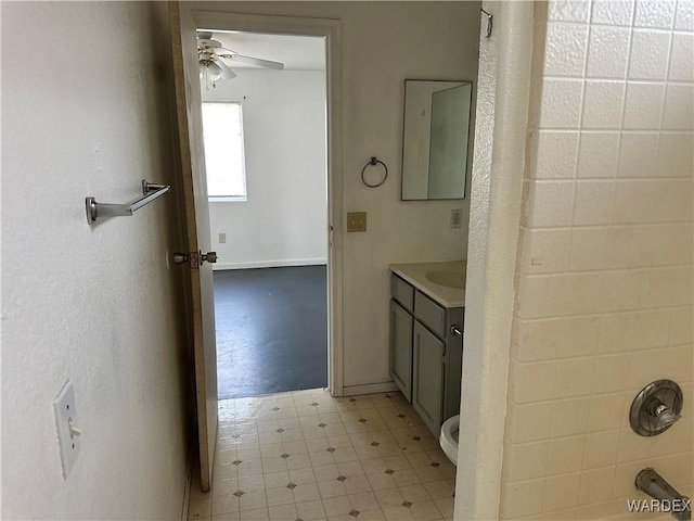 full bathroom featuring toilet, ceiling fan, tile patterned floors, vanity, and washtub / shower combination