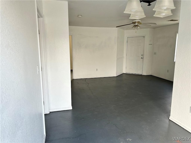 empty room with visible vents, concrete flooring, and a ceiling fan