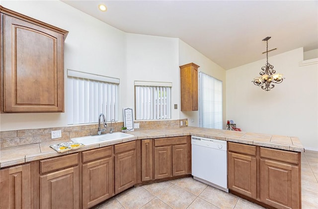 4049 S Cassidy Dr, Fort Mohave, AZ 86426 - kitchen with dishwasher, a sink, a peninsula, light tile patterned floors, and pendant lighting