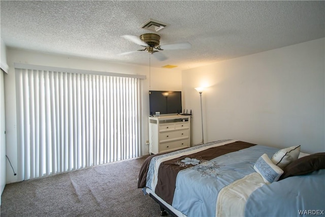 carpeted bedroom with visible vents, ceiling fan, and a textured ceiling