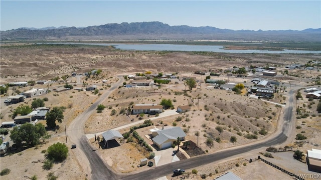 birds eye view of property featuring a water and mountain view and view of desert