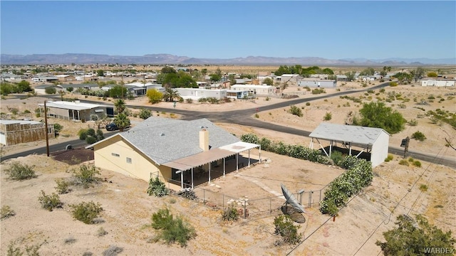 drone / aerial view featuring a mountain view and a desert view