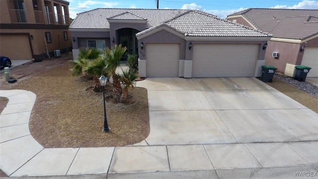 1728 E Alcazar Way, Fort Mohave, AZ 86426 - ranch-style house with stucco siding, driveway, a tile roof, an attached garage, and central AC unit