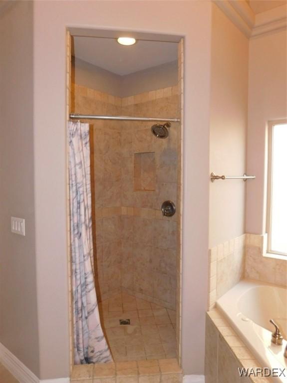 full bathroom with a garden tub and a stall shower