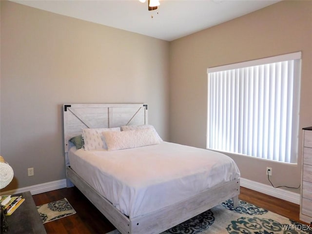 bedroom with ceiling fan, baseboards, and wood finished floors