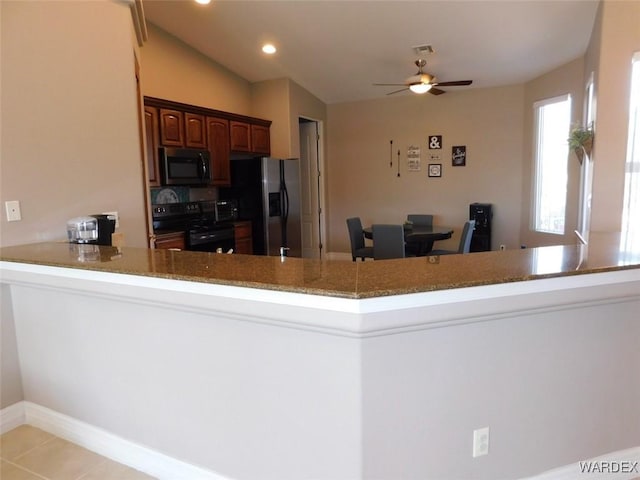 kitchen with visible vents, a peninsula, stainless steel fridge with ice dispenser, recessed lighting, and black range with electric stovetop