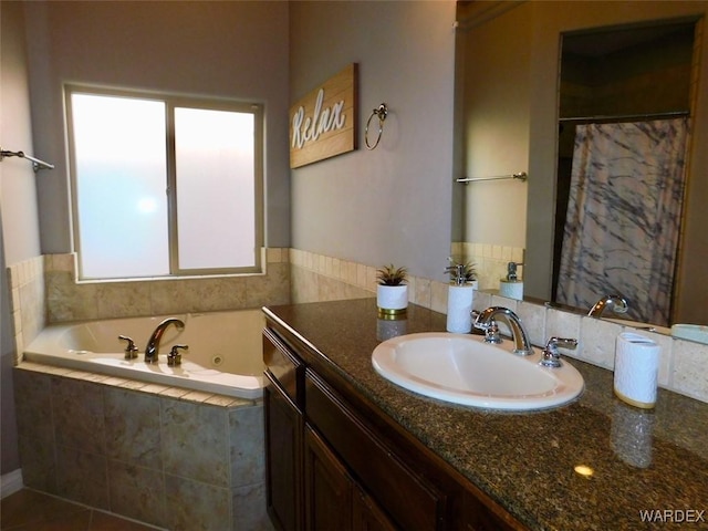 full bathroom with a tub with jets and vanity