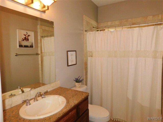 bathroom with toilet, vanity, and shower / bathtub combination with curtain