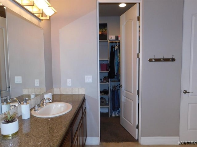 bathroom featuring vanity and a spacious closet