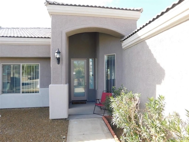 property entrance featuring stucco siding