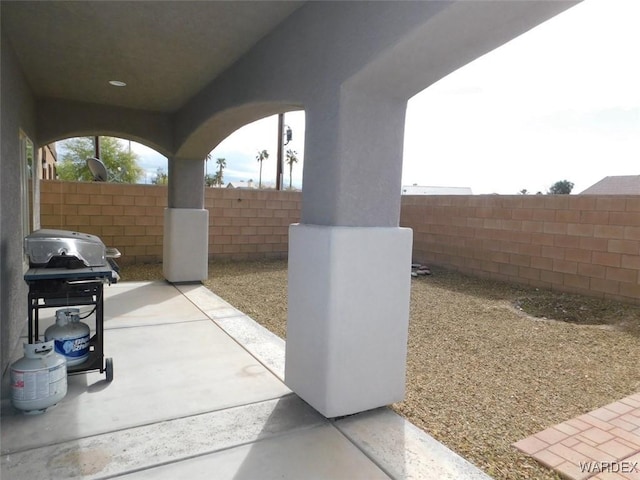 view of patio / terrace with area for grilling and fence