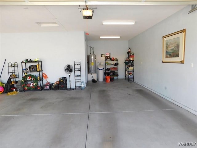 garage with water heater and a garage door opener