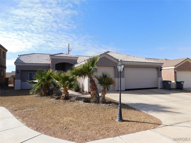 single story home with stucco siding, a tiled roof, an attached garage, and driveway