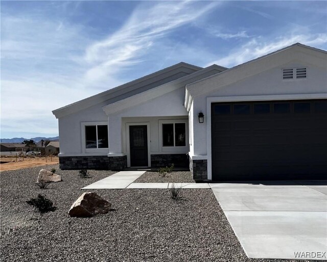 entrance to property with stone siding, a patio, and stucco siding